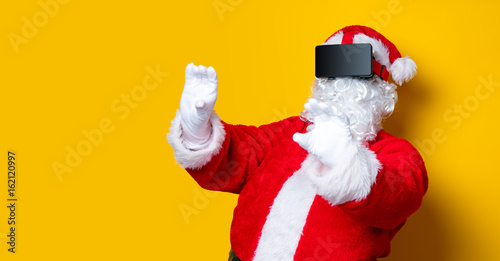 Funny Santa Claus have a joy with VR glasses
