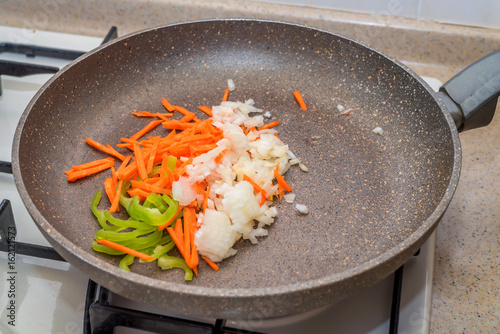 Chopped vegetables on frying pan healthy food