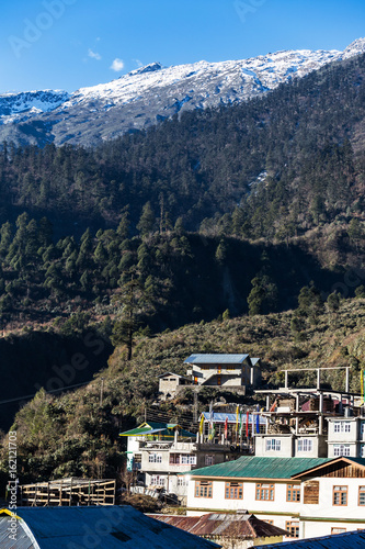 Mountain with little snow on the top with village in the morning with sunlight at Lachen in North Sikkim, India. © artitwpd