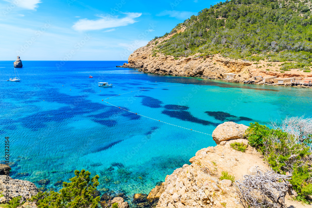 View of Cala Benirras beach with azure blue sea water, Ibiza island, Spain View of Cala Benirras beach with azure blue sea water, Ibiza island, Spain