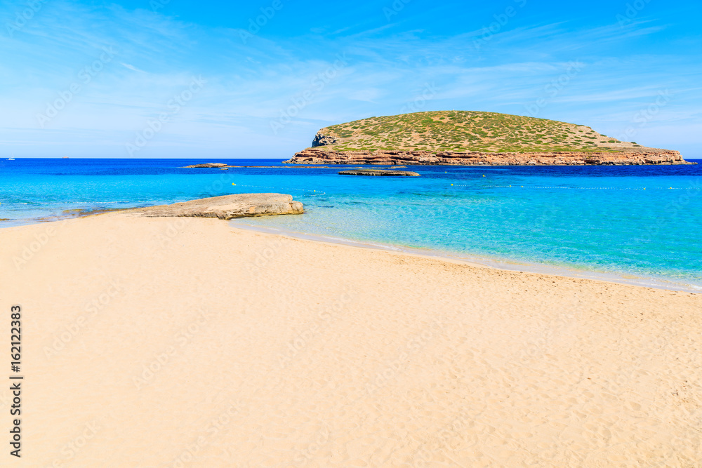 Beautiful sandy Cala Comte beach with azure blue sea water, Ibiza island, Spain Beautiful sandy Cala Comte beach with azure blue sea water, Ibiza island, Spain