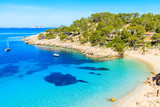 View of beautiful beach in Cala Salada famous for its azure crystal clear sea water, Ibiza island, Spain