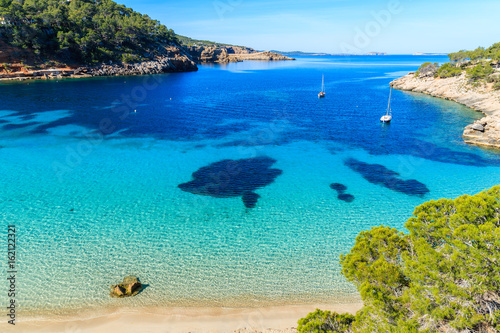 Fototapeta Naklejka Na Ścianę i Meble -  View of beautiful beach in Cala Salada famous for its azure crystal clear sea water, Ibiza island, Spain