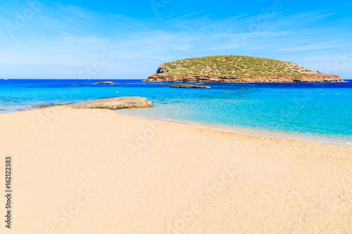 Beautiful sandy Cala Comte beach with azure blue sea water, Ibiza island, Spain © pkazmierczak