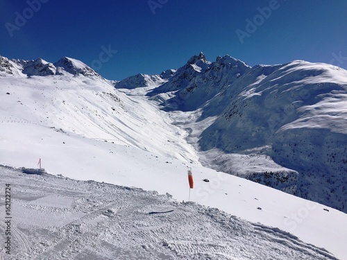 winter landscape view over the alps, snowy mountains, nature covered with snow at winter sunset. St. Moritz the Swiss Alps