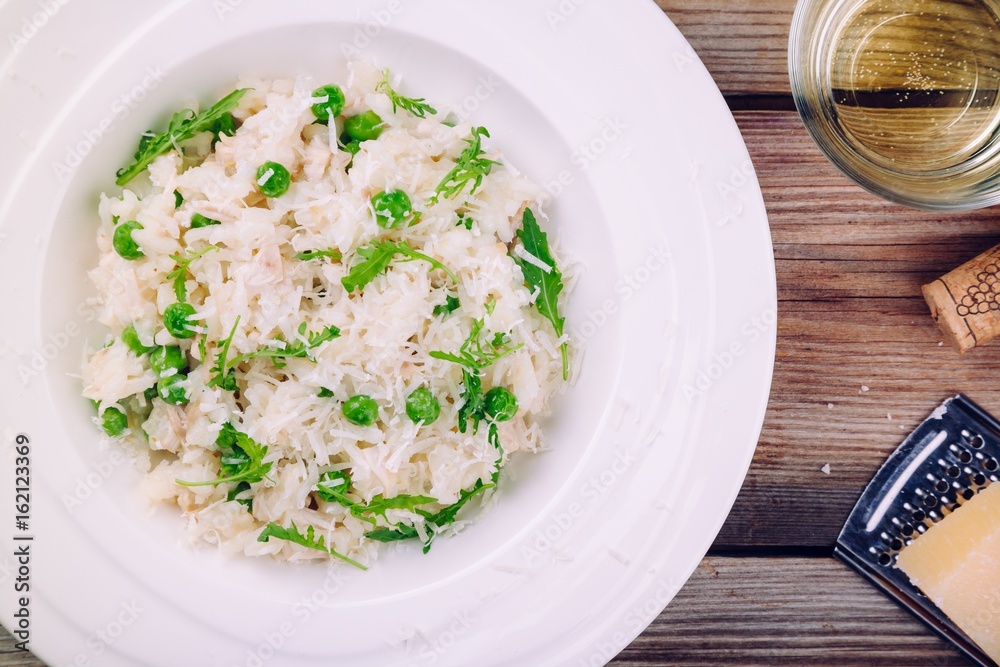Homemade risotto with chicken, green peas, arugula and parmesan Homemade risotto with chicken, green peas, arugula and parmesan