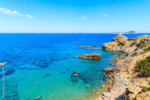 Fototapeta Naklejka Na Ścianę i Meble -  Blue sea water on coast of Ibiza island in Es Figueral bay, Spain