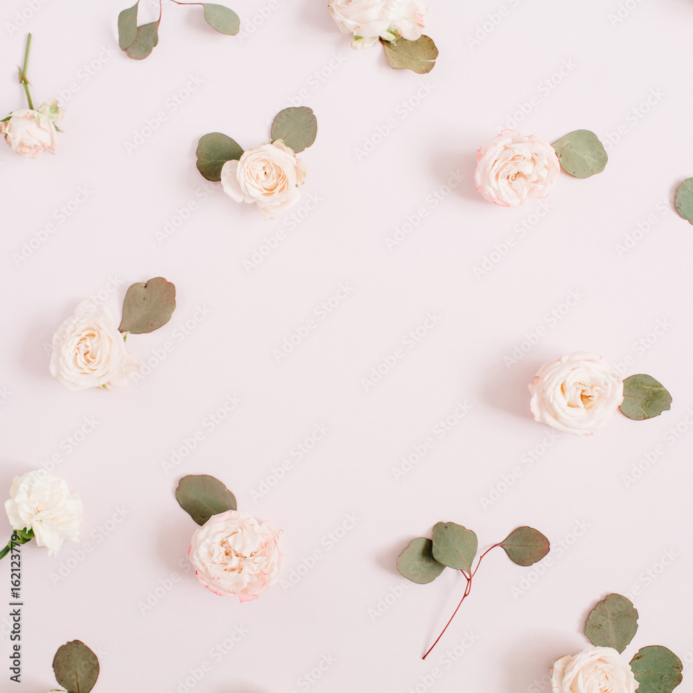 Flowers frame made of beige roses, eucalyptus branches on pale pastel pink background. Flat lay, top view. Floral texture background. Flowers frame made of beige roses, eucalyptus branches on pale pastel pink background. Flat lay, top view. Floral texture background.