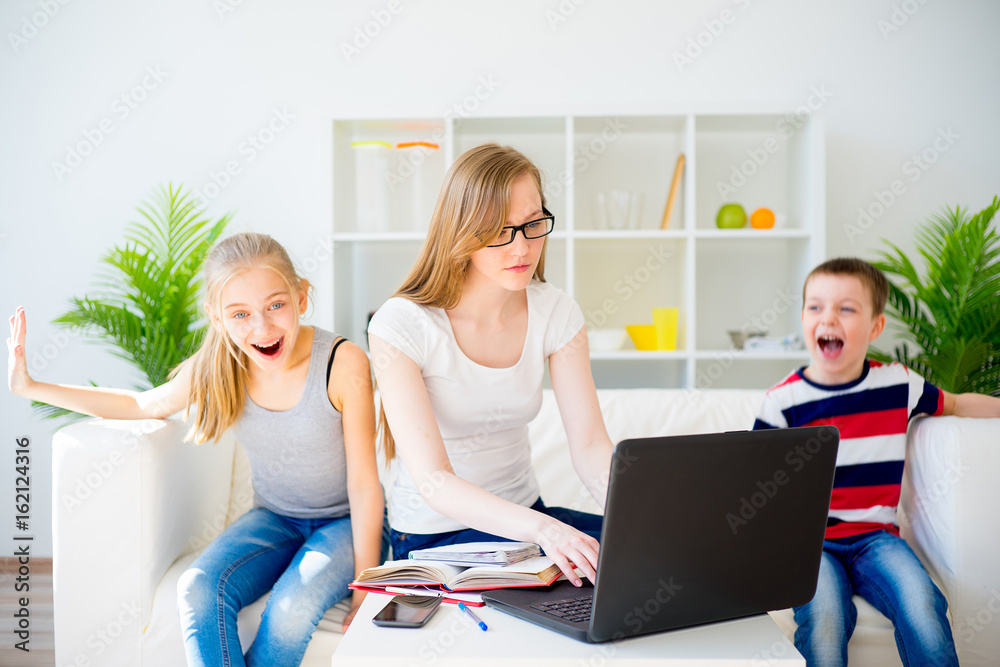 Tired young mother working oh her laptop Tired young mother working oh her laptop