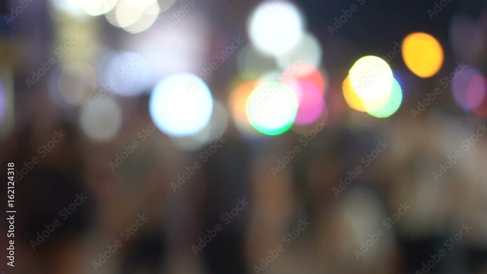 Blurred silhouettes of anonymous people walking on the street with colorful lights at night - video in fast motion Blurred silhouettes of anonymous people walking on the street with colorful lights at night - video in fast motion