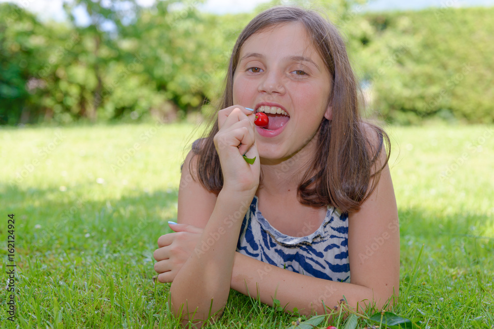 pretty teenage girl outdoors with cherry pretty teenage girl outdoors with cherry