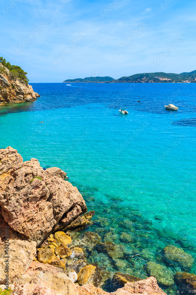 Fototapeta premium Rocks and azure blue sea of Cala San Vicente bay, Ibiza island, Spain