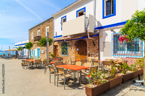 Restaurants and bars on coastal promenade in Santa Eularia town, Ibiza island, Spain. photo