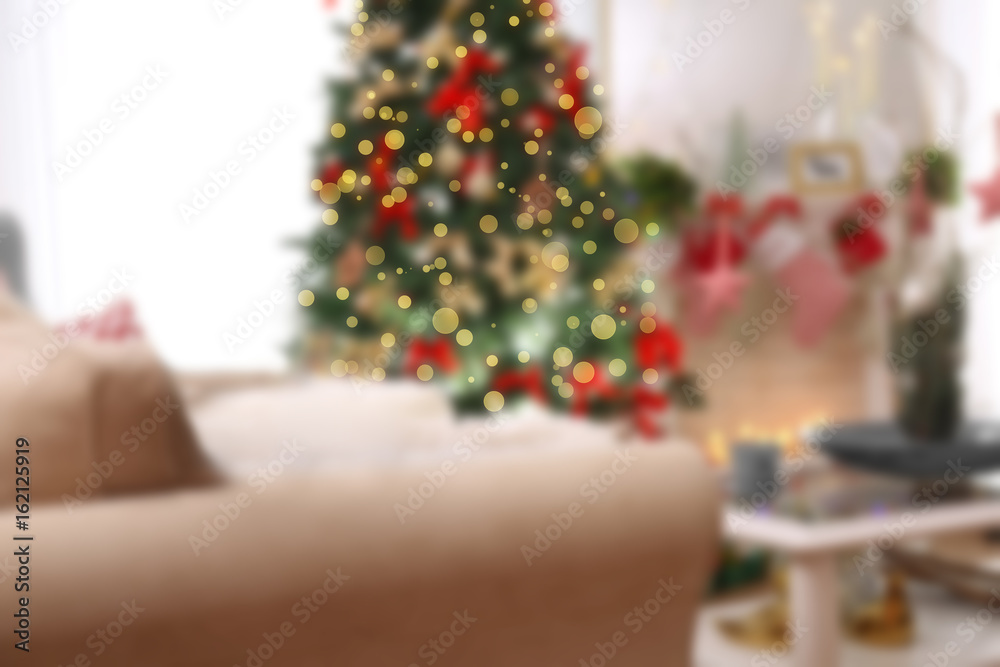 Tabby cat on sofa in beautiful living room decorated for Christmas Tabby cat on sofa in beautiful living room decorated for Christmas
