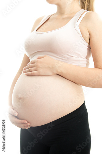 Big belly of pregnant woman on white isolated background