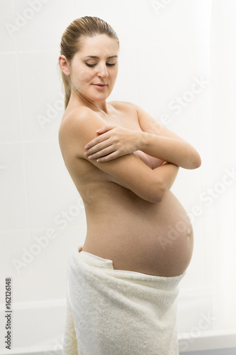 Beautiful young pregnant woman having posing in bathroom © Кирилл Рыжов