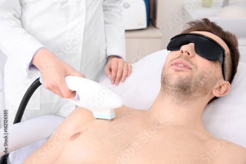 Handsome man getting laser ...