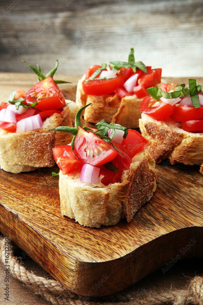 Bruschetta with tomatoes, herbs and oil on toasted garlic cheese bread toasted with chopped tomatoe