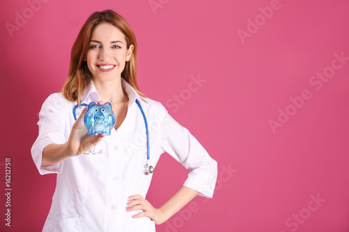 Happy young doctor holding ...