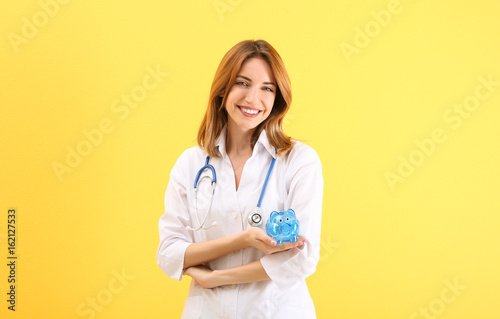Happy young doctor holding ...