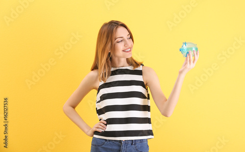 Happy young woman holding p...