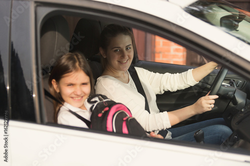 Beautiful mother driving car with daughter to school © Кирилл Рыжов