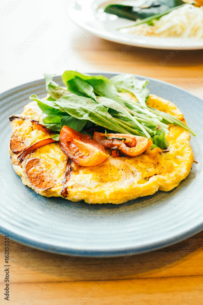 Fried eggs omelette in white plate