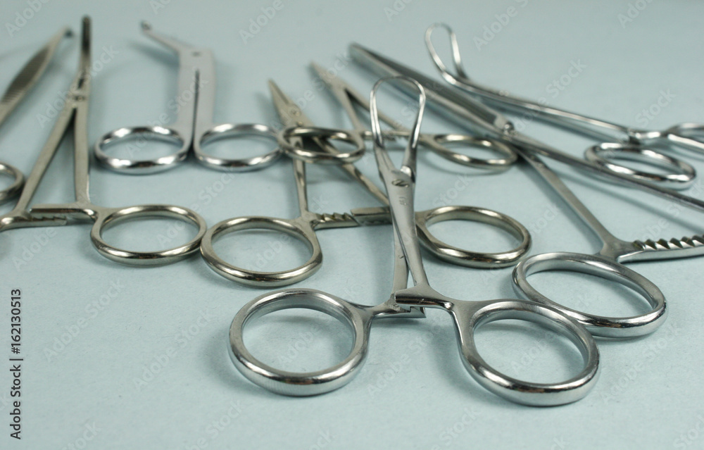 Medical surgical Instruments on blue background. Selective focus Medical surgical Instruments on blue background. Selective focus