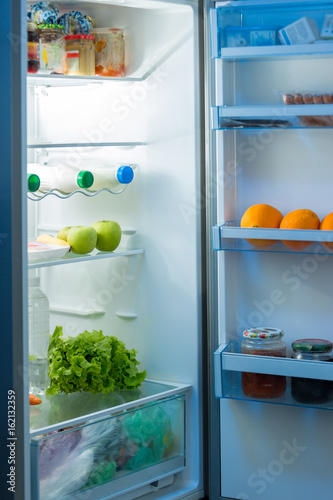 Open refrigerator on kitchen at night
