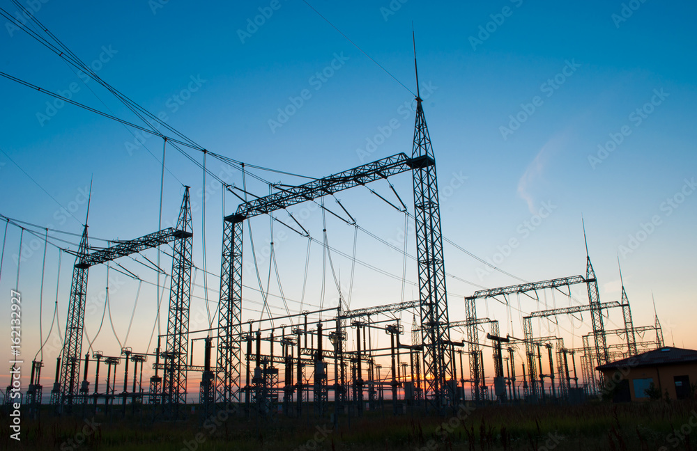 high-voltage power lines at sunset