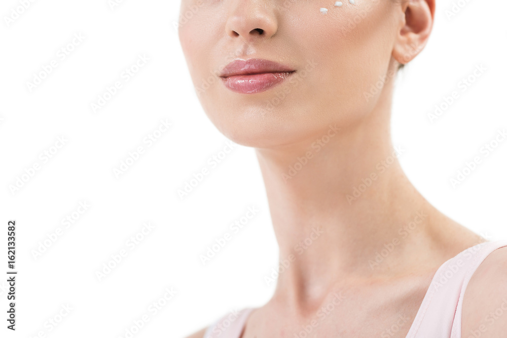Half of face of youthful happy lady using cosmetics