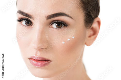 Serious attractive girl with decorative cosmetics on face