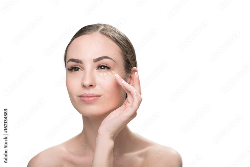 Cheery attractive girl using decorative facial make-up