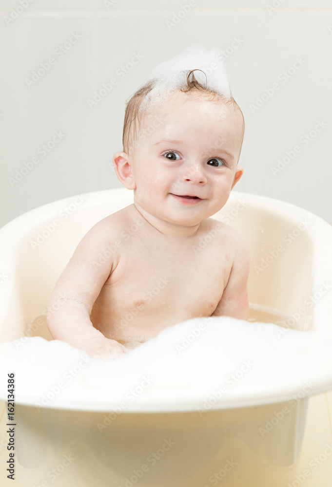 Adorable baby boy with foam on head having bath time Adorable baby boy with foam on head having bath time