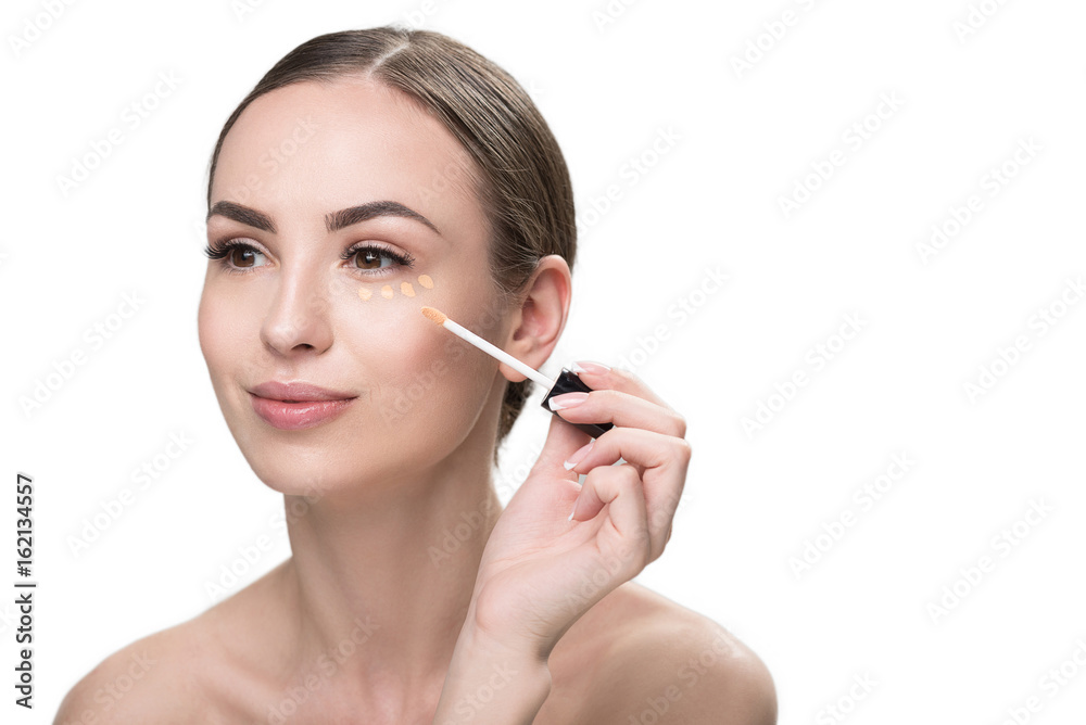 Happy beautiful girl applying visage cosmetic