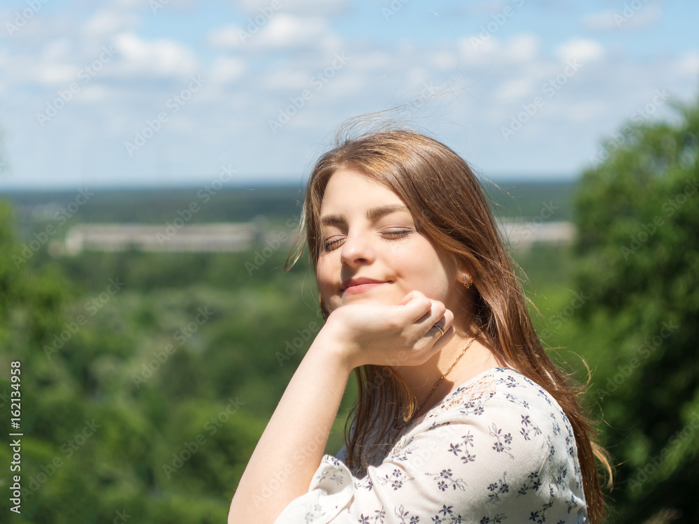 portrait of girl sitting and enjoying a Sunny day at the Park