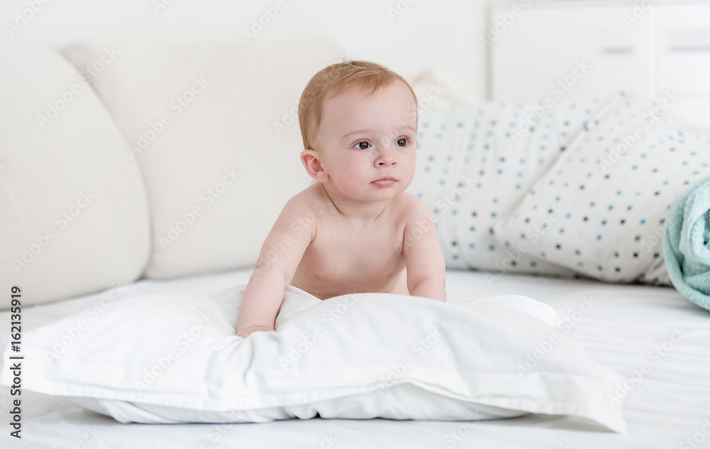 Adorable baby boy relaxing on pillow Adorable baby boy relaxing on pillow