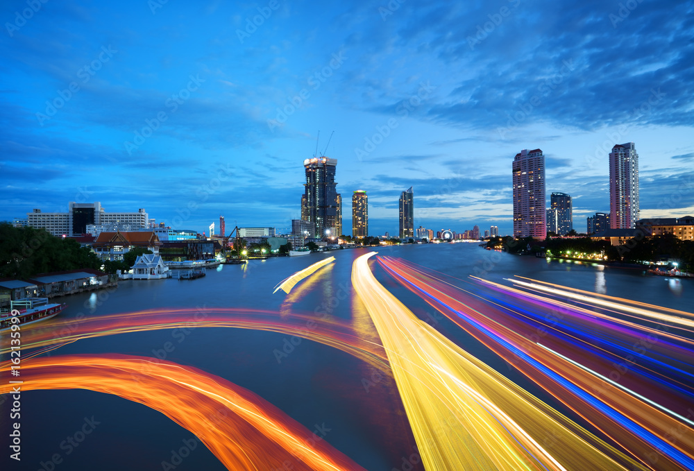 Fototapeta premium Beautiful cityscape of Bangkok viewing traffic on Chao Phraya river in twilight from Taksin Bridge , Thailand