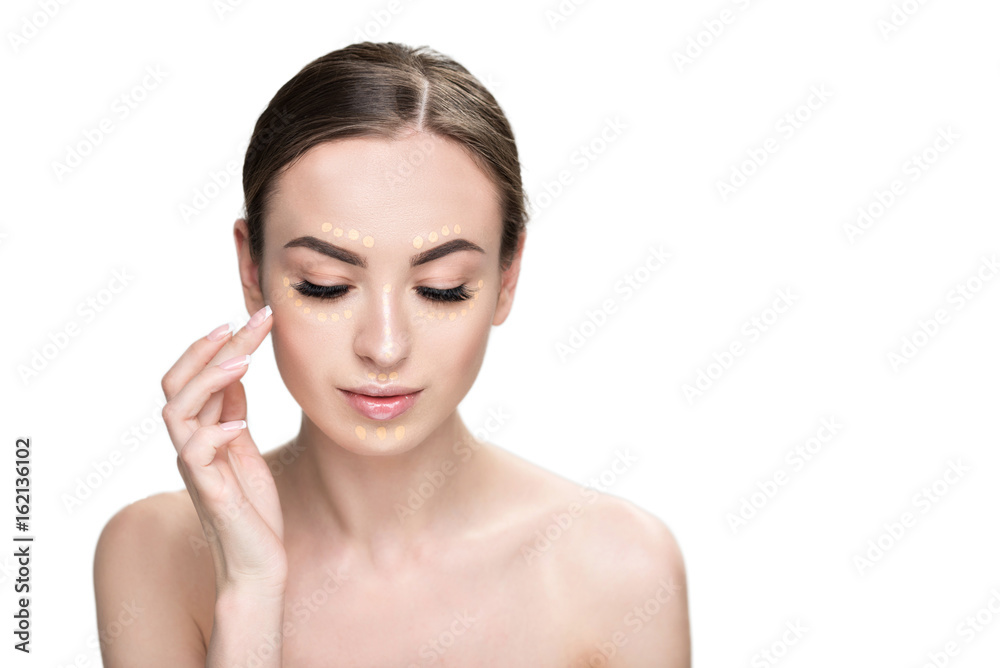 Attractive woman doing base make-up Attractive woman doing base make-up