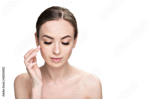 Attractive woman doing base make-up