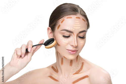 Happy young woman creating facial features