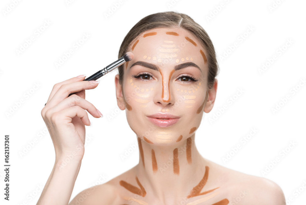 Cheerful smiling young woman using cosmetic brush Cheerful smiling young woman using cosmetic brush