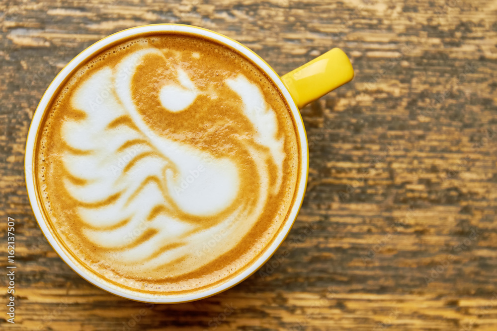 Latte art swan, top view. Coffee cup macro.