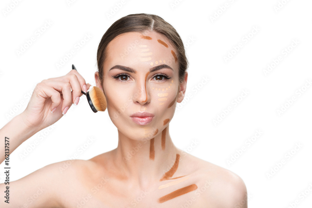 Confident attractive young woman using brush