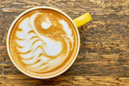 Latte art swan, top view. Coffee cup macro.