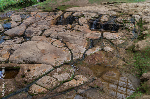 Ancient riverbed carvings called Fuente de Lavapatas in archeological park in San Agustin, Colombia photo