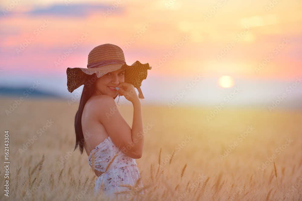 Closeup portrait of smiling young caucasian woman in nature. Cheerful young beautiful woman enjoying a day in natural environment at sunset.
