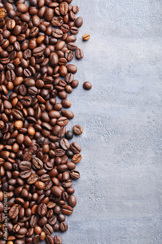 Roasted coffee beans on a grey table