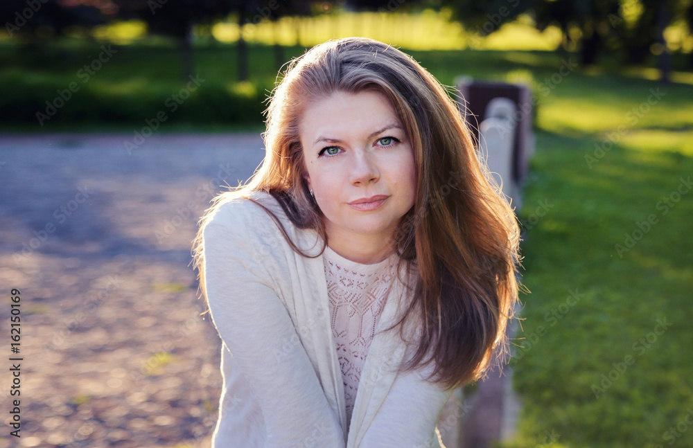 Beautiful young woman in the park. Portrait