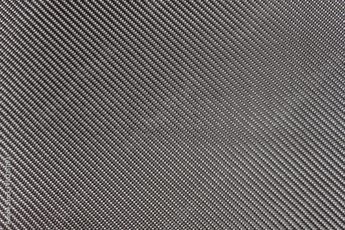Black woven carbon fiber composite texture for reinforcement car parts.